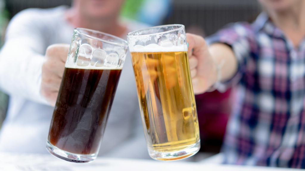 Two people clinking glasses of dark and light craft beer in celebration in Fort Collins, Colorado.