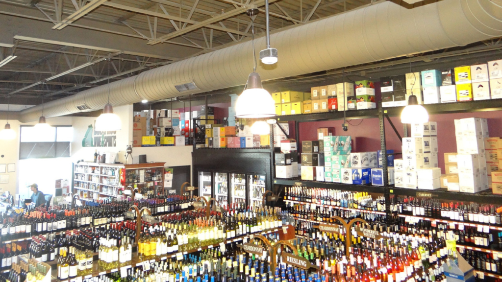 Interior of Bullfrog Wine & Spirit showcasing a wide selection of wines and spirits, organized by variety with clearly labeled sections, an ideal holiday shopping destination.